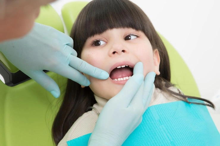 close up little girl having her teeth examined by dentist 549566 483