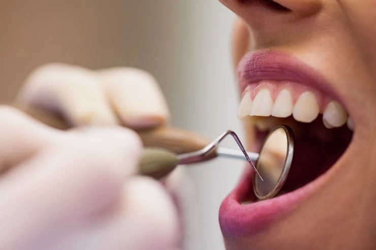 dentist examining female patient with tools 107420 65429