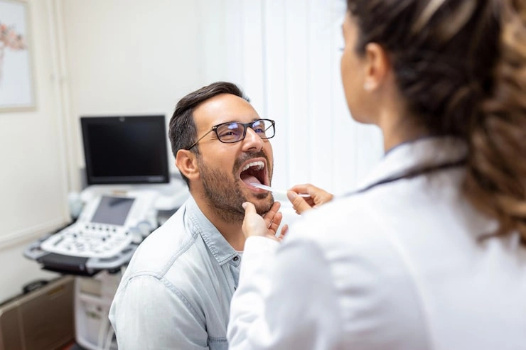 doctor using inspection spatula examine patient throat ent doctor doing throat exam patient opened his mouth throat checkup 657921 849