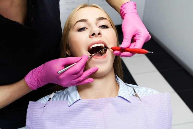 female dentist treating her patient teeth 8353 1660