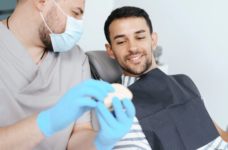 male dentist medical mask explaining artificial teeth smiling patient clinic 158595 7725