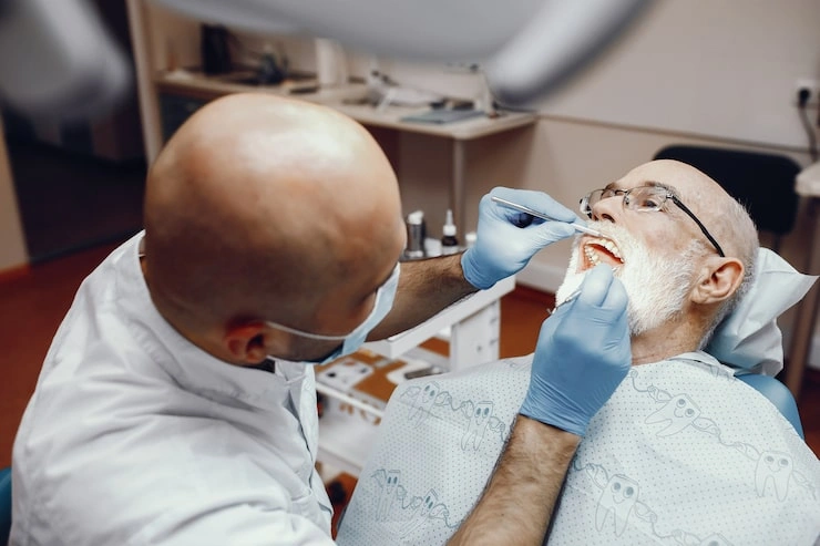 old man sitting dentist s office 1157 19454