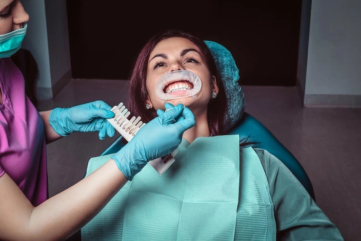 woman dentist checks level teeth whitening with dentist s color dentist office 613910 17771