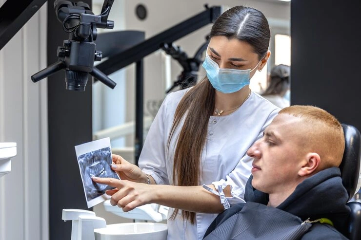 young female dentist showing patient dental xray dentistry concept 169016 67306
